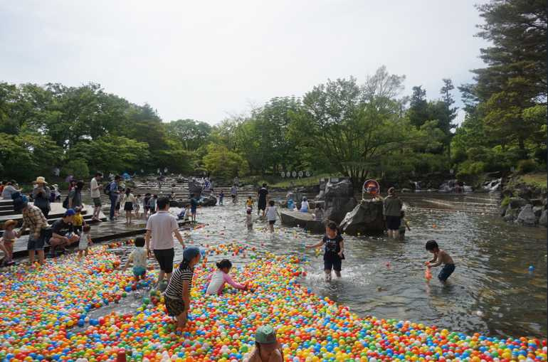 戲水池漂浮滿滿彩球，大人小孩的嬉笑聲交織著清涼水聲，捕捉夏日限定的畫面。（©府中市郷土の森博物館）