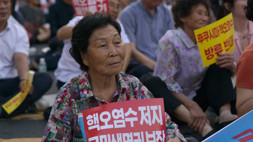 海女們為了海洋生態及永續環境，團結走上街頭抗議，出發前往聯合國發表聲明。（圖／Apple TV+提供）