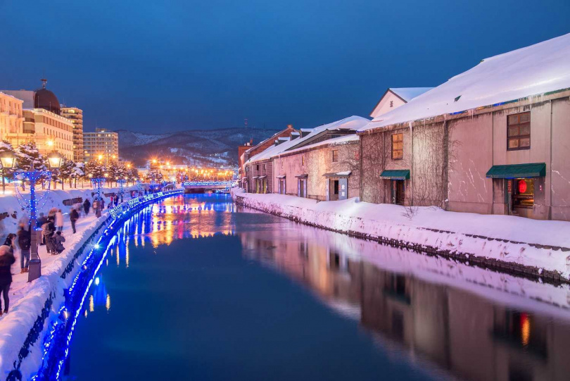 北海道小樽運河於聖誕期間全面點燈，投射至水面的光輝，搭配銀白雪景，絕對是冬天必訪景點。（圖／旅天下）